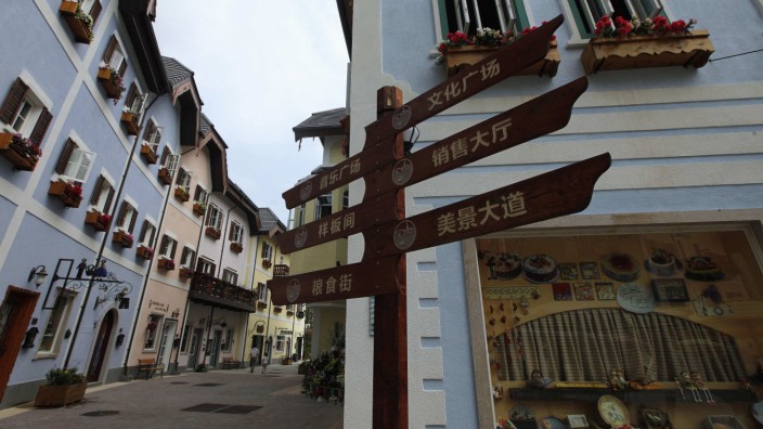A Chinese road sign is seen at the replica of Austria's UNESCO heritage site, Hallstatt village, in Huizhou