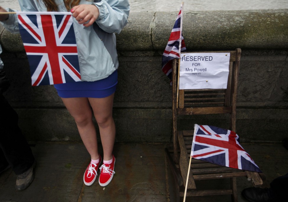 A spectator has reserved a seat ahead of the start of the pageant along the River Thames in central London