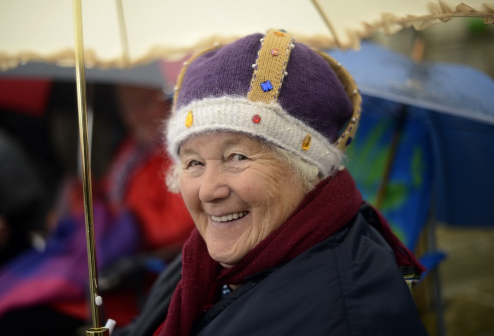 Spectator Janet Mead smiles as she waits for the start of the pageant along the River Thames in central London