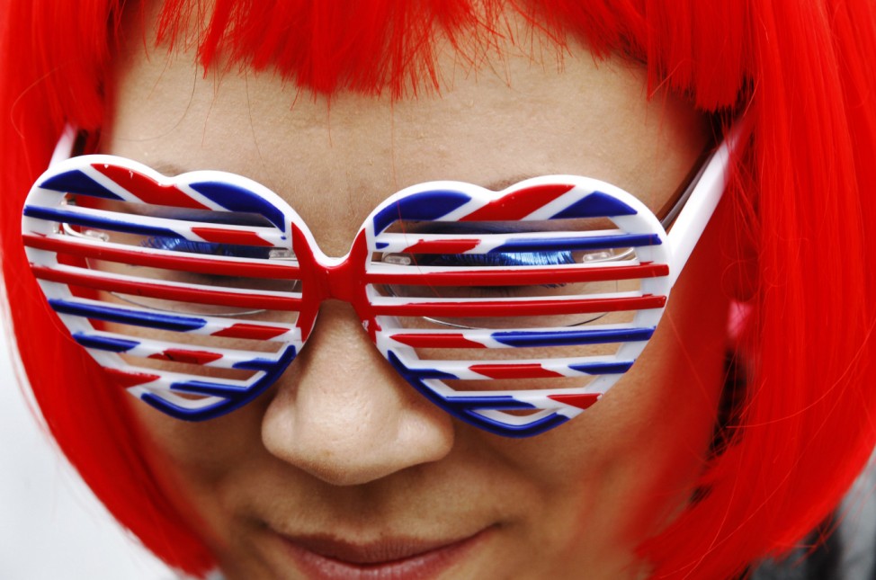 A woman wears a red wig and Union Flag glasses at the Goldsmith Avenue Street Party to mark the Diamond Jubilee of Britain's Queen Elizabeth in Ealing, west London