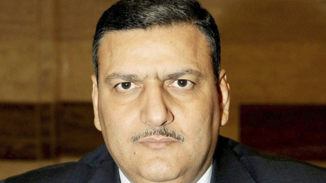 Handout shows Syria's former agriculture minister Riyad Hijab, who has been named as new prime minister