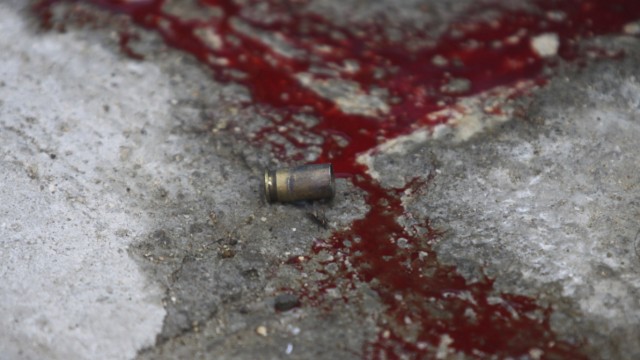 A bullet shell is seen near blood at a crime scene in Emiliano Zapata neighborhood in Acapulco