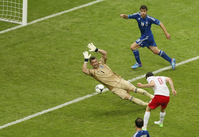 Poland's Lewandowski scores the first goal of the tournament past Greece's Chalkias during their Euro 2012 Group A match at the National Stadium in Warsaw