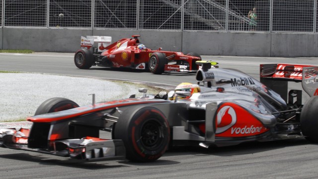 McLaren Formula One driver Hamilton and Ferrari's Alonso drive during the Canadian F1 Grand Prix at the Circuit Gilles Villeneuve in Montreal