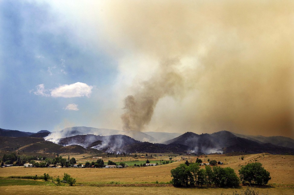 Smoke and flames encroach upon homes and ranches on the eastern front of the High Park fire near Laporte