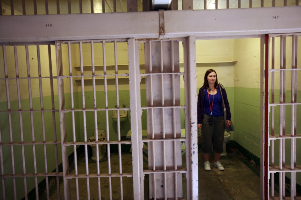 A tourist visits a prison cell along cell block 'B' at Alcatraz Island in San Francisco