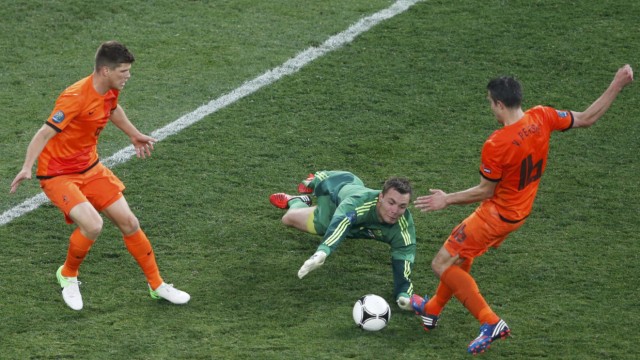 Denmark's Andersen is challenged by Netherlands' Huntelaar and van Persie during their Group B Euro 2012 soccer match at the Metalist stadium in Kharkiv