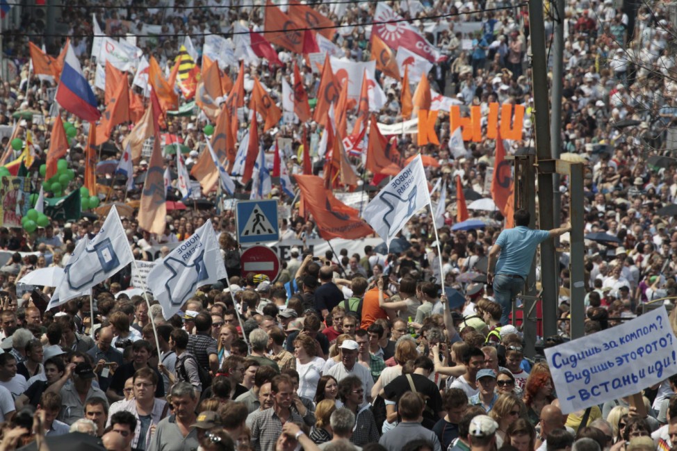 Participants march with flags and placards during an anti-government protest in Moscow