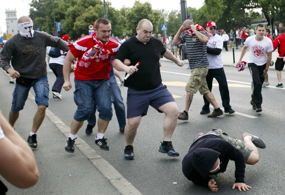 Polish and Russian soccer fans clash outside the National Stadium in Warsaw