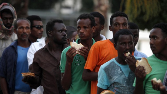 African refugees and migrant workers  stand in charity food line in south Tel Aviv