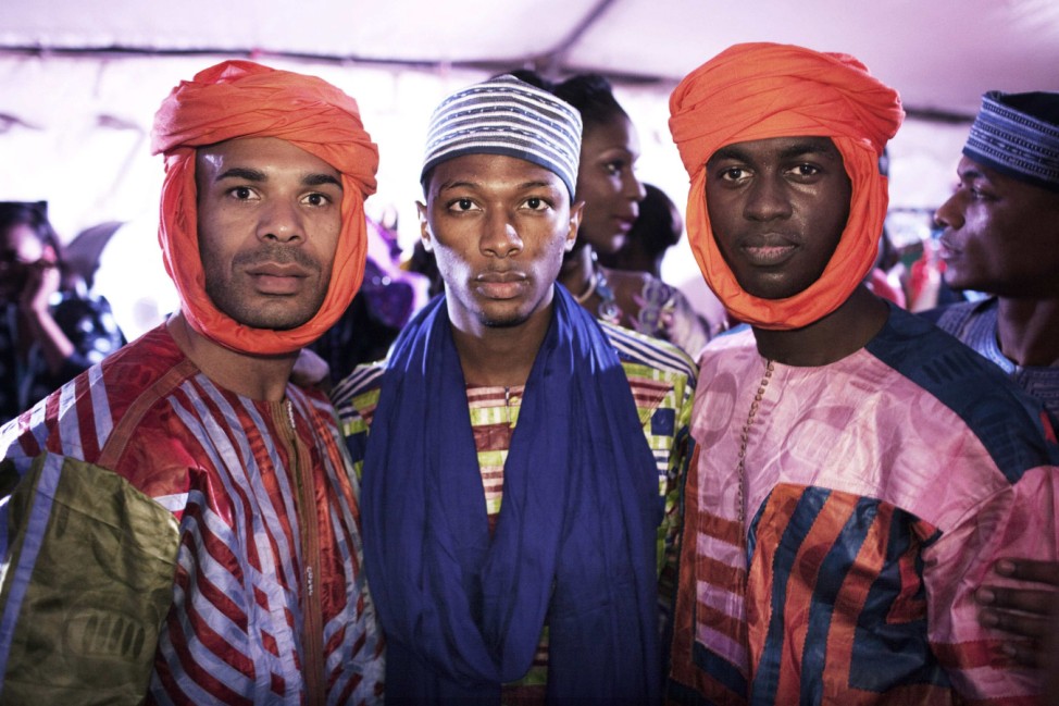 Models wear creations by designer Alphady backstage during Dakar Fashion Week