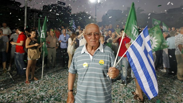 A supporter of Socialist PASOK party stands amidst confetti during pre-election rally at Korydallos suburb near Athens