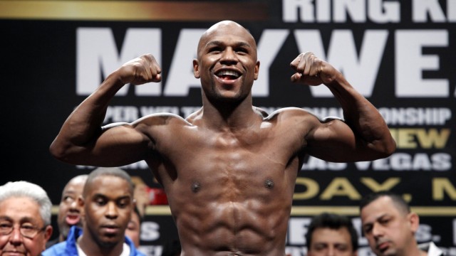 File picture shows Floyd Mayweather Jr. of the U.S. flexing on the scale during an official weigh-in in Las Vegas, Nevada