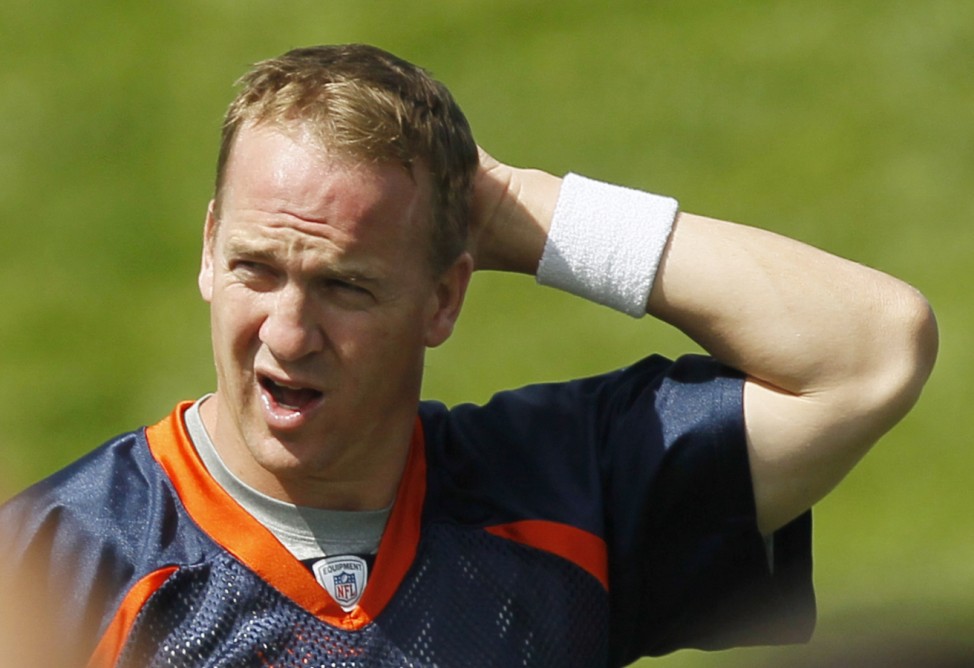 Denver Broncos quarterback Manning stretches in the second OTA session at the Broncos NFL training facility in Denver