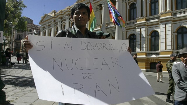 A man holds a sign that reads 'Yes to Iran's  nuclear development' during a visit by Iran's President Mahmoud Ahmadinejad in La Paz