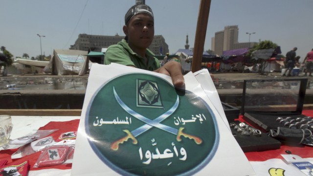 A street vendor sells merchandise of the Muslim Brotherhood during a celebration for victory in the election at Tahrir square in Cairo
