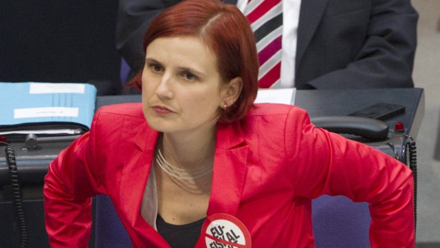 The co-leader of Die Linke party Kipping wears sticker denouncing EU fiscal pact as she listens to Chancellor Merkel deliver government policy statement in in parliament in Berlin