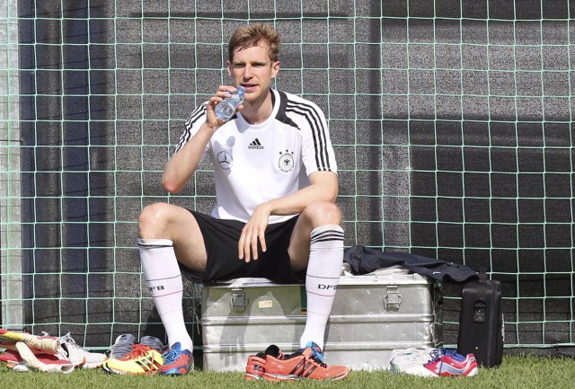 Germany's national soccer player Mertesacker drinks during a training session after winning their Euro 2012 soccer match against Portugal in Gdansk