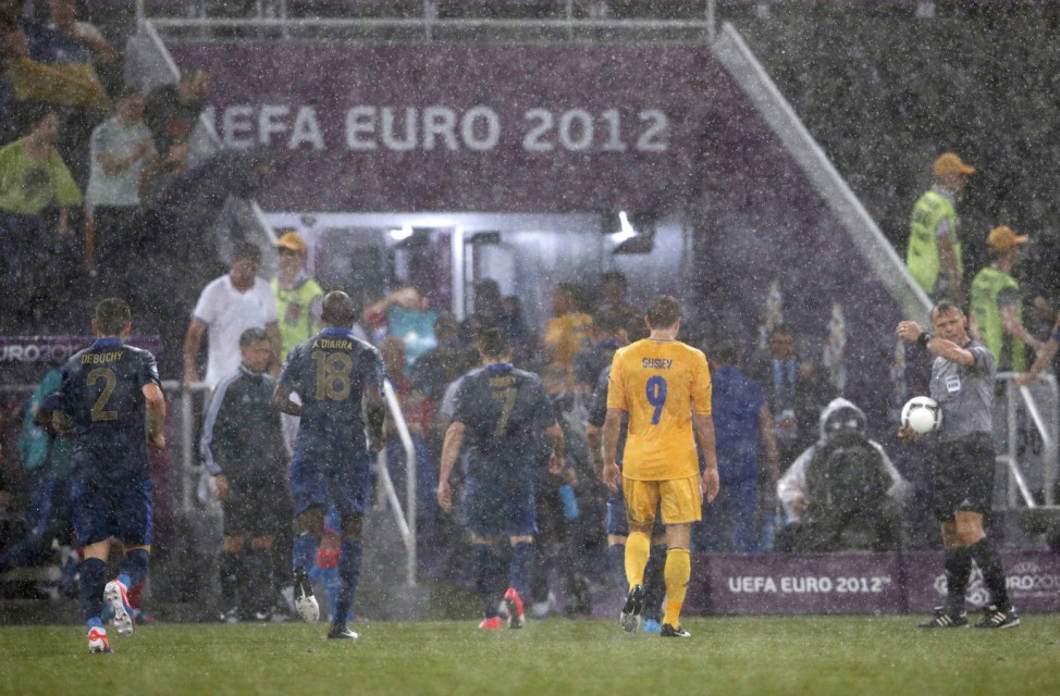 Match referee Bjorn Kuipers of Netherlands sends Ukraine's and France's players to the dressing rooms after suspending the Group D Euro 2012 soccer match due to a heavy storm at the Donbass Arena in Donetsk