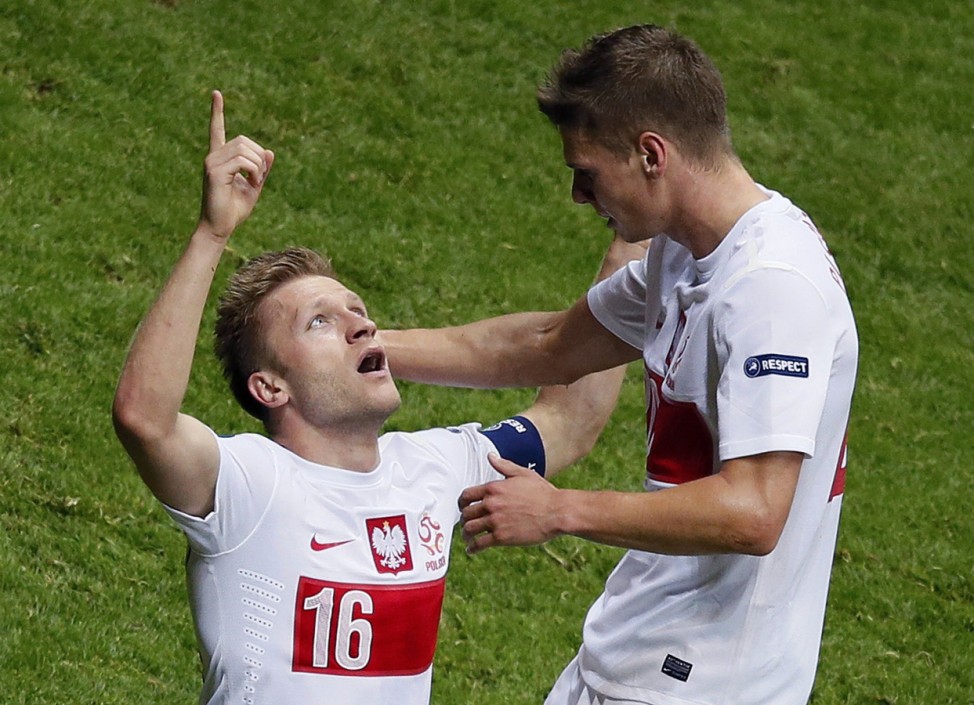 Poland's Blaszczykowski celebrates with Piszczek after scoring a goal against Russia during their Group A Euro 2012 soccer match at the National stadium in Warsaw