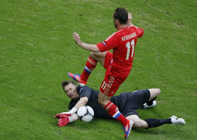 Russia's Kerzhakov jumps over Poland's goalkeeper Tyton during their Group A Euro 2012 soccer match at the National stadium in Warsaw
