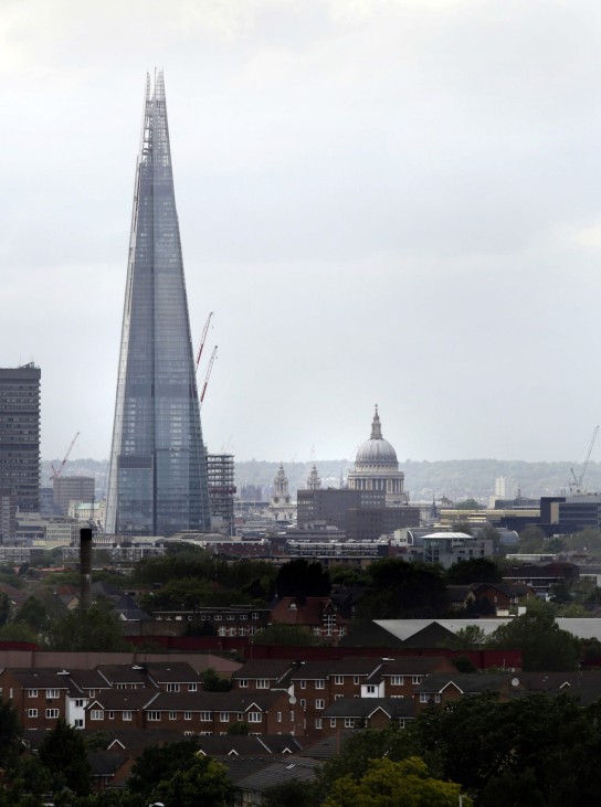 The Shard skyscraper towers over Saint Paul's Cathedral in a view from south London