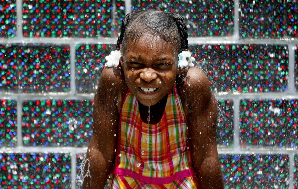 Kale Currin cools off in the Crown Fountain at Millennium Park in Chicago