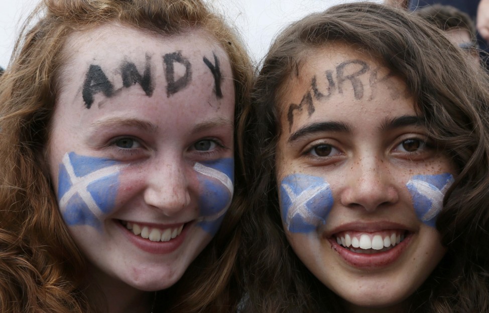 Two fans pose for a photograph before the men's singles final tennis match between Roger Federer of Switzerland and Andy Murray of Britain at the Wimbledon Tennis Championships in London