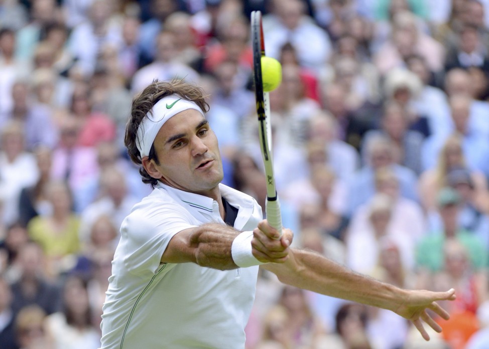 Roger Federer of Switzerland hits a return to Andy Murray of Britain in their men's singles final tennis match at the Wimbledon Tennis Championships in London