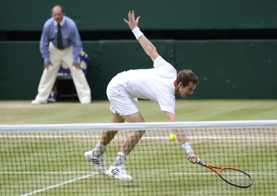 Andy Murray of Britain hits a return to Roger Federer of Switzerland in their men's singles final tennis match at the Wimbledon Tennis Championships in London