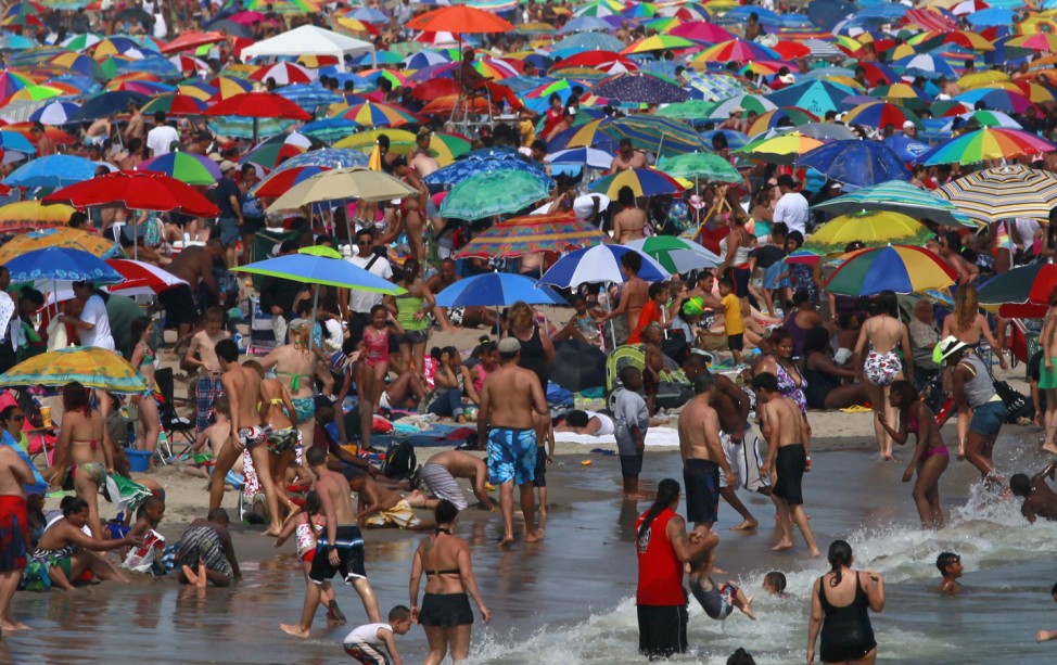 People crowd at the beach of Coney Island in Brooklyn