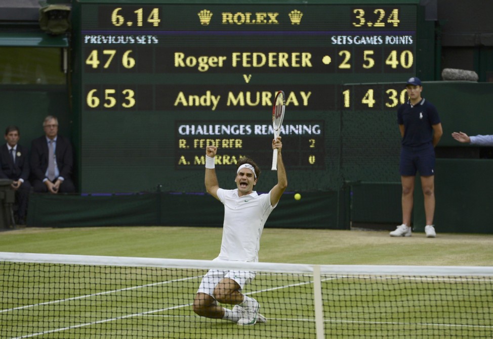 Roger Federer of Switzerland celebrates after defeating Andy Murray of Britain in their men's final tennis match at the Wimbledon Tennis Championships in London