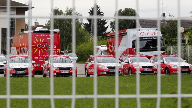 Cofidis buses are parked in front of the hotel of Cofidis cycling team in Bourg-en-Bresse
