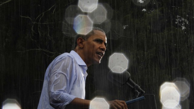 U.S. President Barack Obama speaks in the reain during a campaign event in Glen Allen