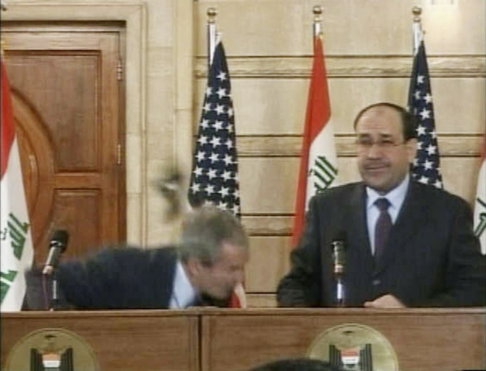 Video frame grab of U.S. President George W. Bush ducking from a shoe during a news conference in Baghdad