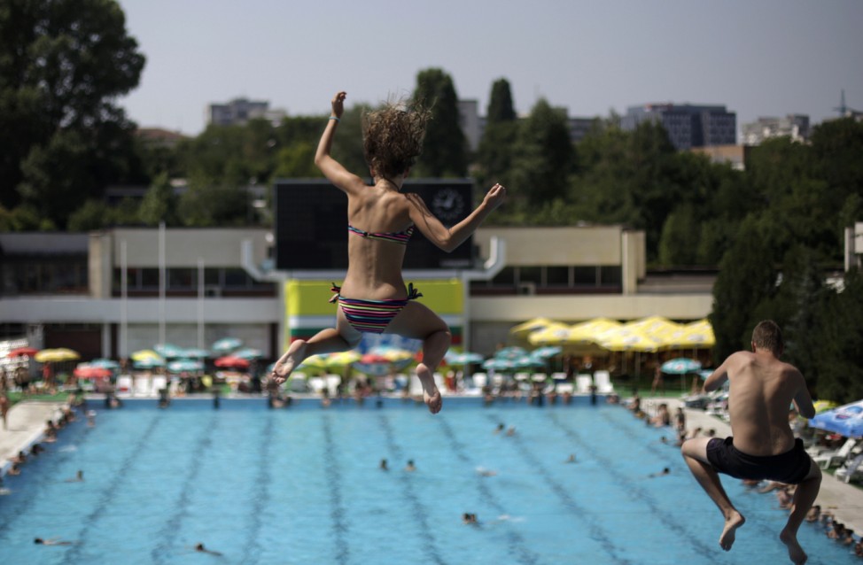 People jump into a swimming pool in Sofia