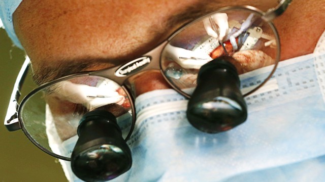 A heart surgery operation led by Professor Pirk is reflected in the glasses of doctor Urban at the IKEM in Prague