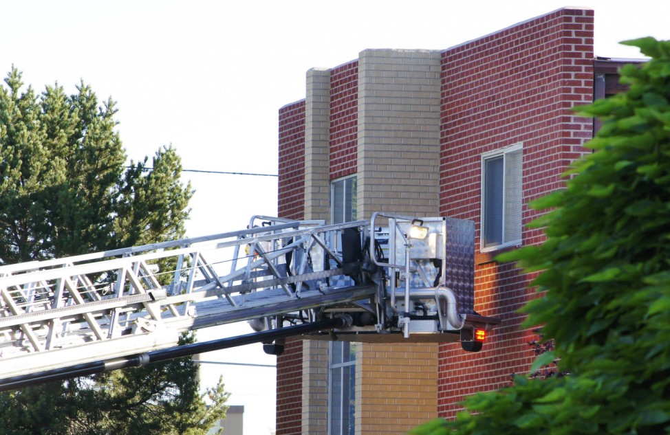 A fire truck ladder is pictured outside the Denver shooting suspect's apartment building  in Aurora