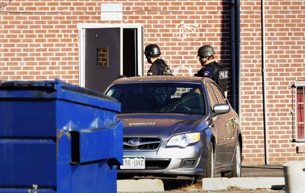 Aurora Police officers are pictured outside an apartment building in Aurora