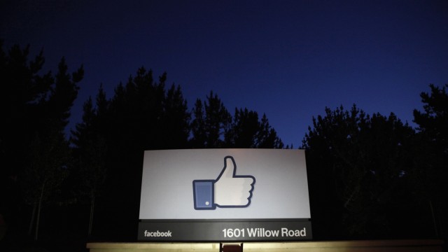 File photo of the sun rising behind the entrance sign to Facebook headquarters in Menlo Park