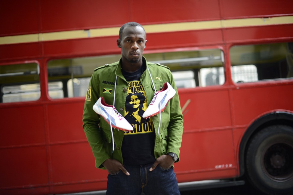 File photo of sprinter Usain Bolt of Jamaica posing with his running spikes and official team uniform for the London 2012 Olympic Opening Ceremony during a photo shoot in London