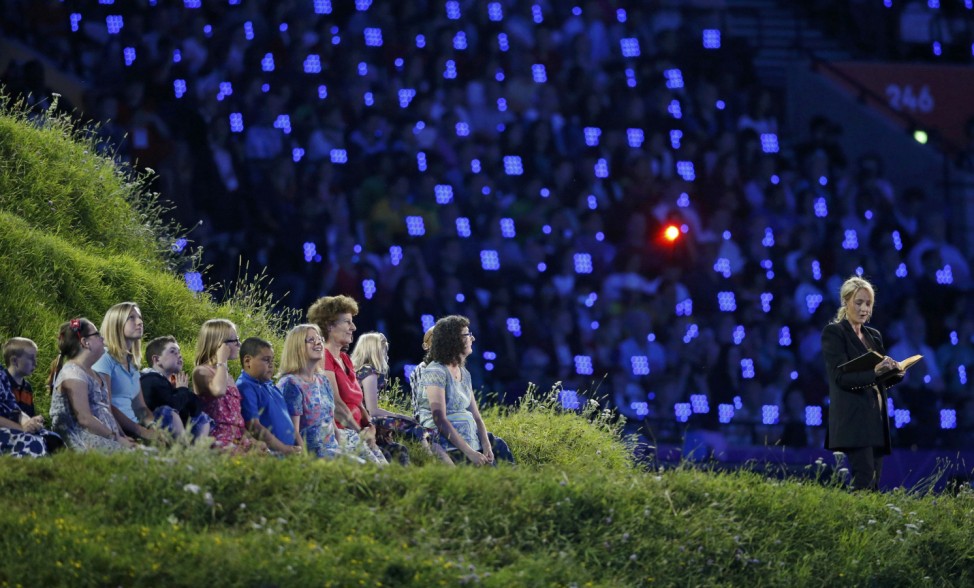 J.K. Rowling, author of the Harry Potter series, reads during the opening ceremony of the London 2012 Olympic Games at the Olympic Stadium
