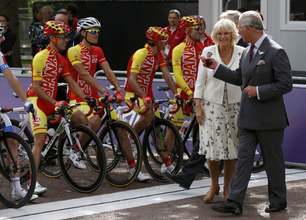 Britian's Prince Charles and Camilla, Duchess of Cornwall, stand in front of the Spainish team before the men's road cycling race at the London 2012 Olympic Games at The Mal