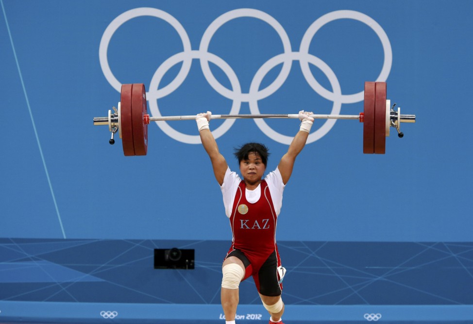 Kazakhstan's Zulfiya Chinshanlo lifts to set new clean and jerk World record and total Olympic record  on the women's 53Kg Group A weightlifting competition at the London 2012 Olympic Games