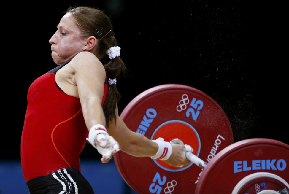 Poland's Aleksandra J Klejnowska-Krzywanska drops the weights during the women's 53Kg Group A weightlifting competition at the London 2012 Olympic Games
