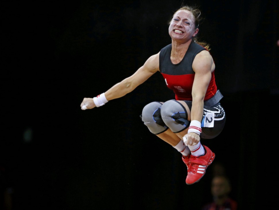 Poland's Aleksandra J Klejnowska-Krzywanska reacts after successful lift on the women's 53Kg Group A weightlifting competition at the London 2012 Olympic Games