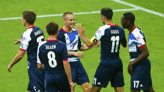 Britain's Ryan Giggs celebrates with team mates after scoring against UAE during their men's preliminary first round Group A soccer match at the London 2012 Olympic Games in the Wembley Stadium in London