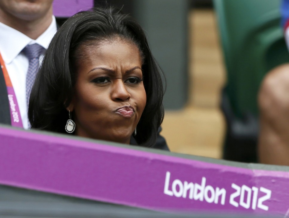 U.S. first lady Michelle Obama reacts as she watches the women's singles tennis match between Williams of the U.S. and Jankovic of Serbia at the All England Lawn Tennis Club during the London 2012 Olympics Games