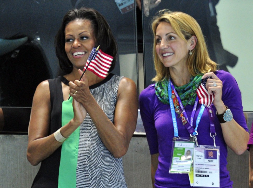 U.S. first lady Michelle Obama claps her hands during the medal presentation ceremony for Ryan Lochte of the U.S., who won the men's 400m individual medley, at the London 2012 Olympic Games at the Aquatics Centre