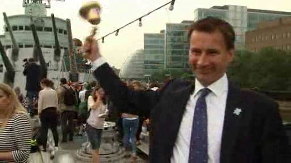 A still image taken from video shows the British minister in charge of the London Olympics Jeremy Hunt ringing an Olympic bell which flew off its handle in London
